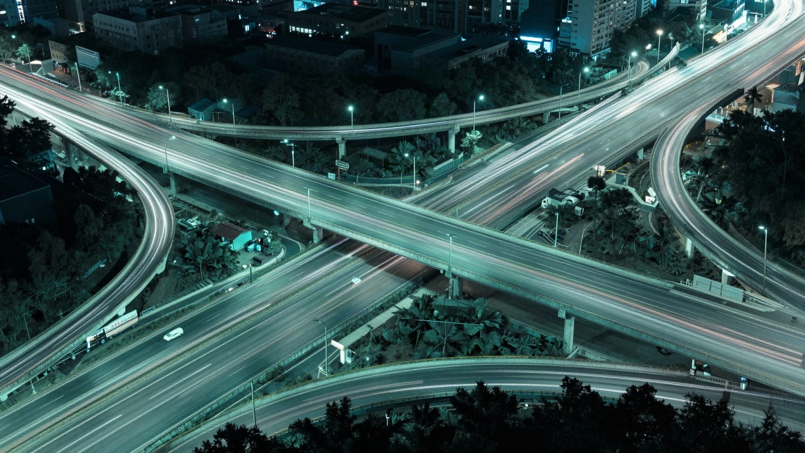 A busy highway interchange at night with streaks of light