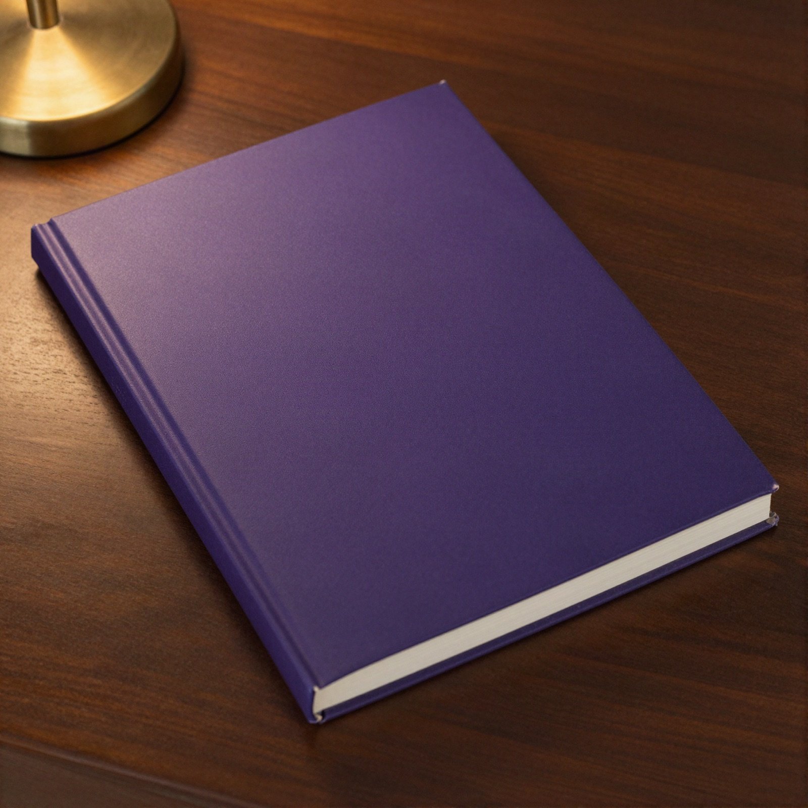 A plain deep purple hardcover book on a dark wooden nightstand beside a brass lamp