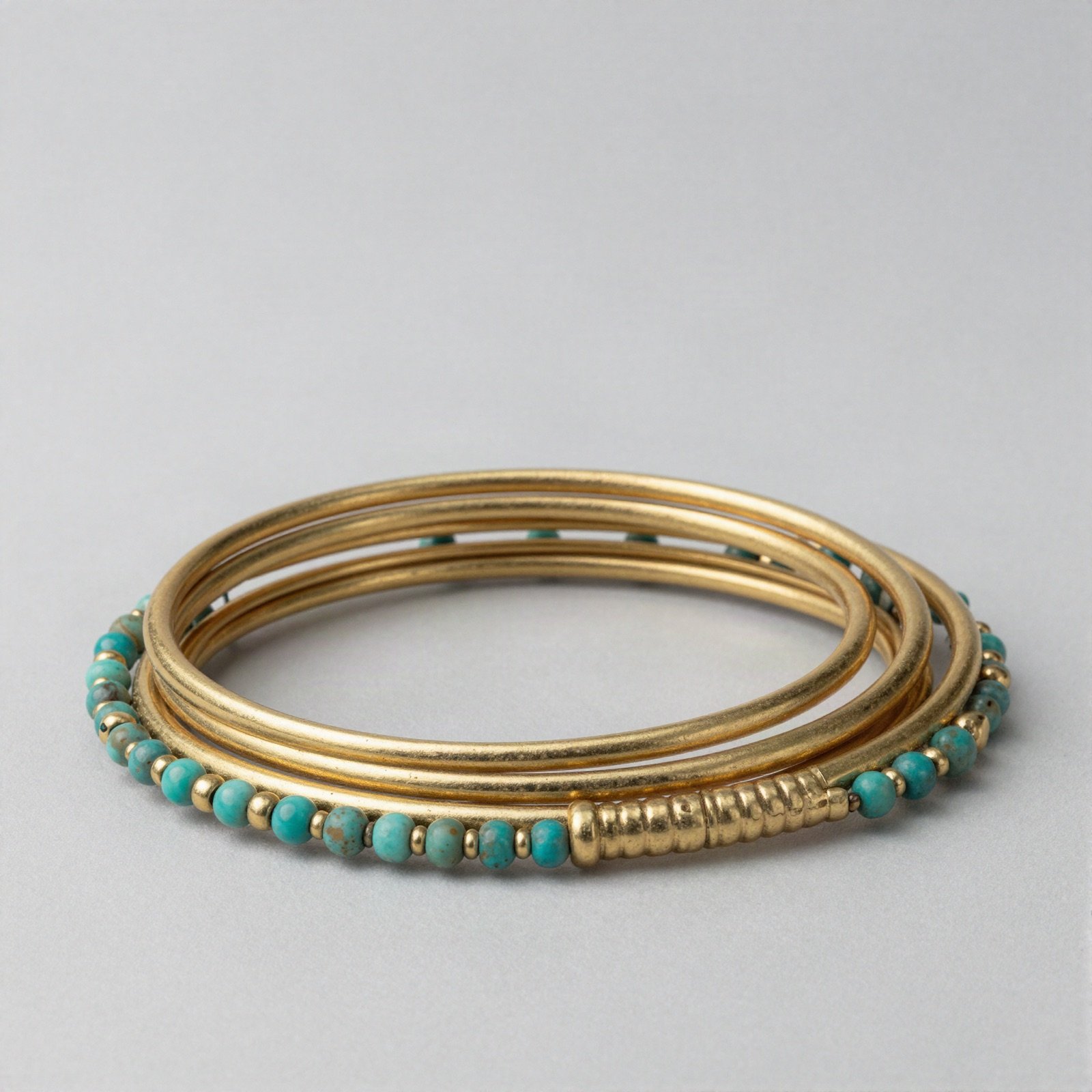 Gold bangle bracelets with turquoise beads