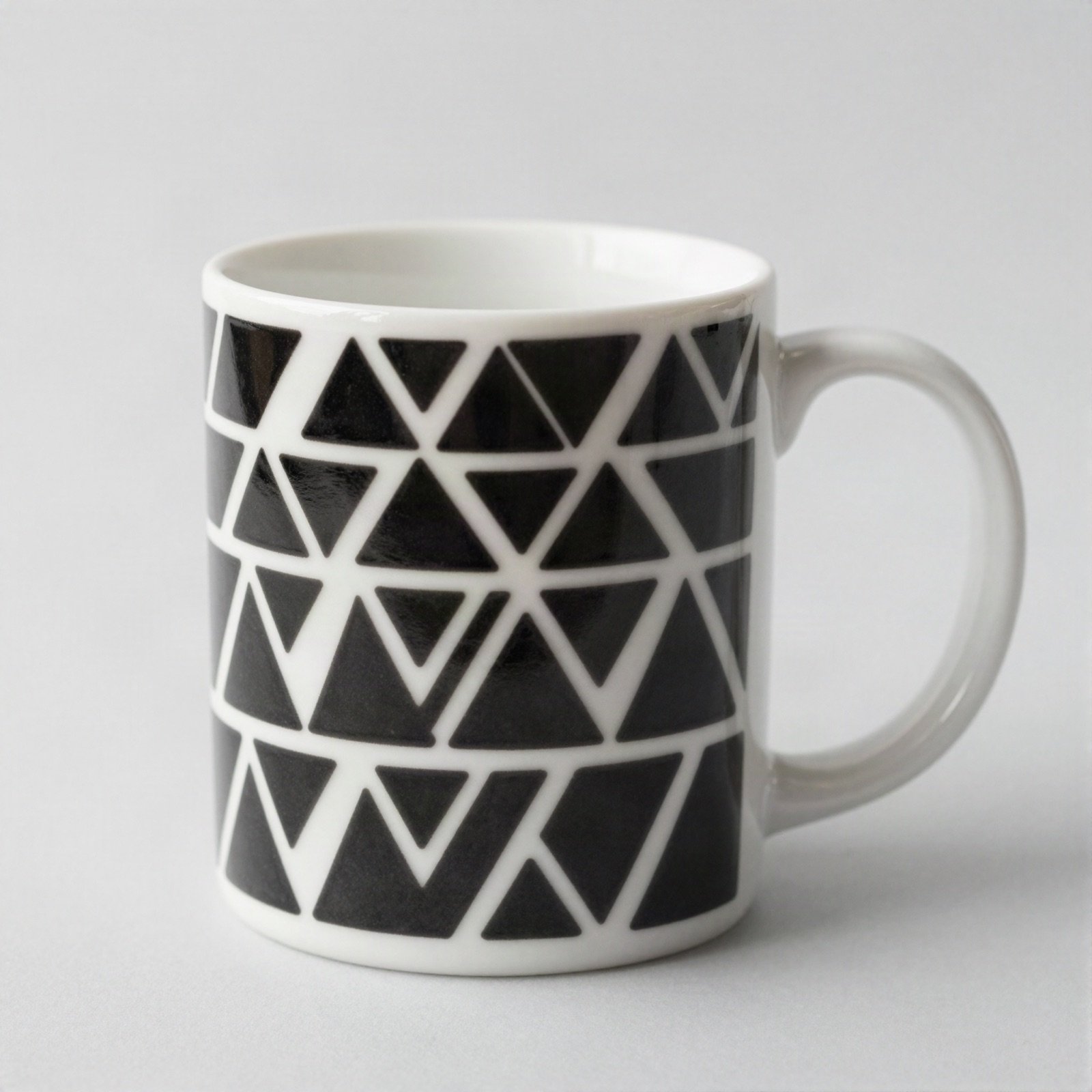 White mug printed with a black triangle pattern