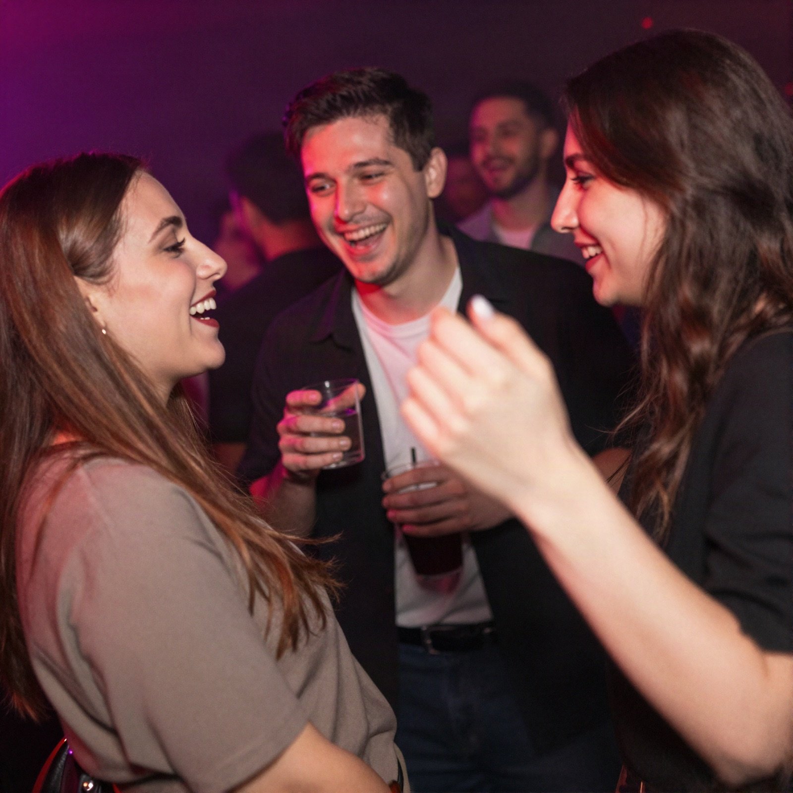 Friends laughing and dancing at a club night