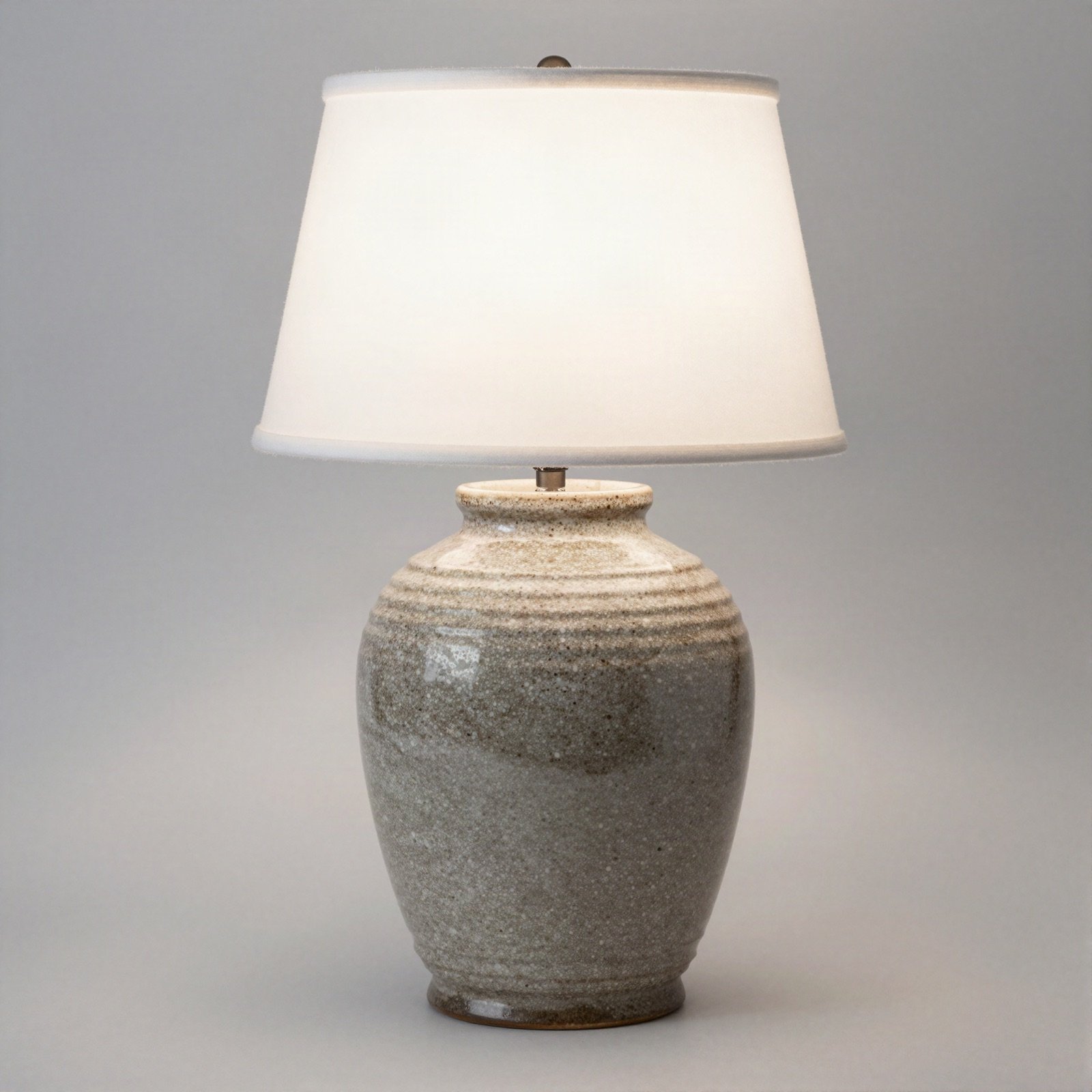 Speckled stoneware table lamp with a white shade