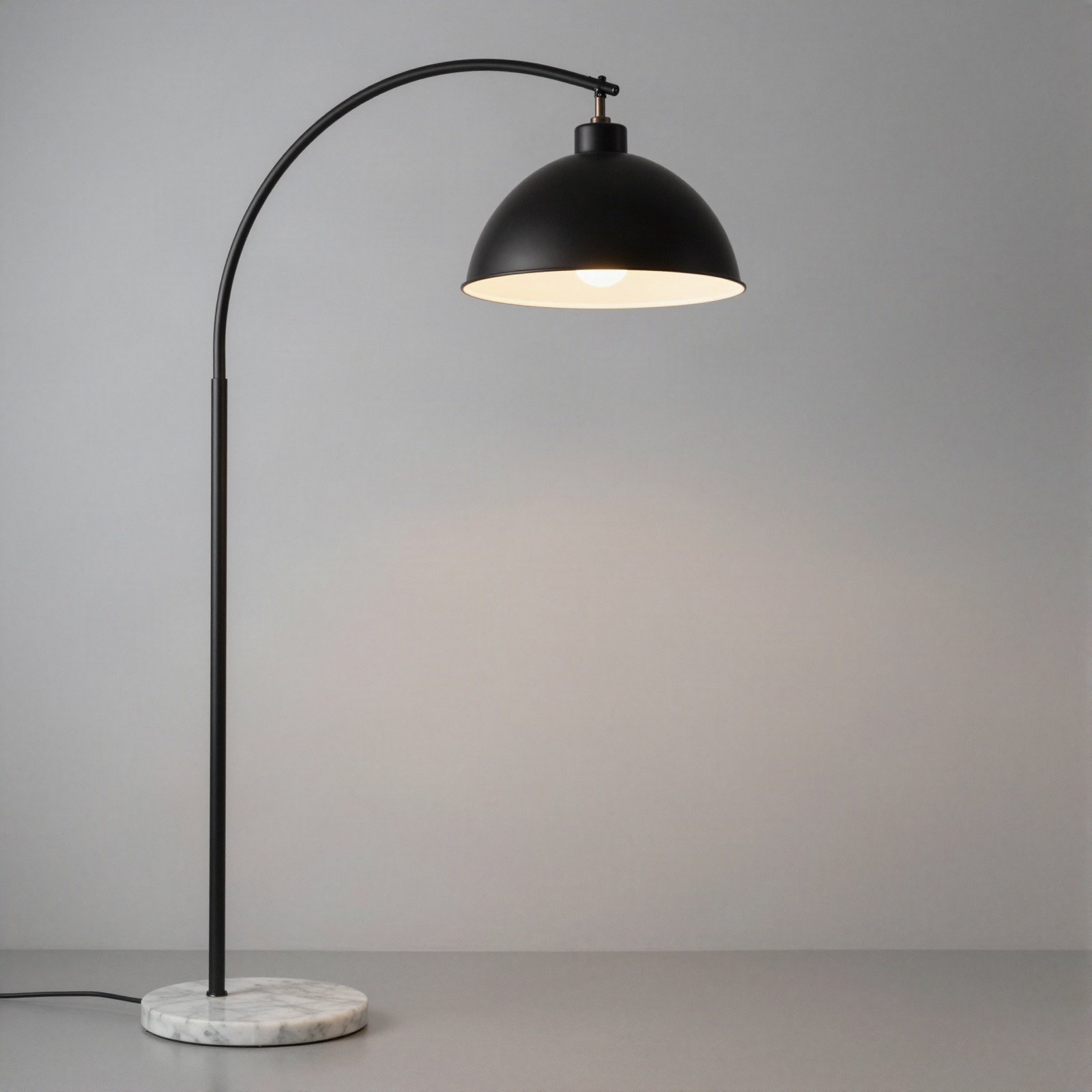 Arched black floor lamp with a marble base