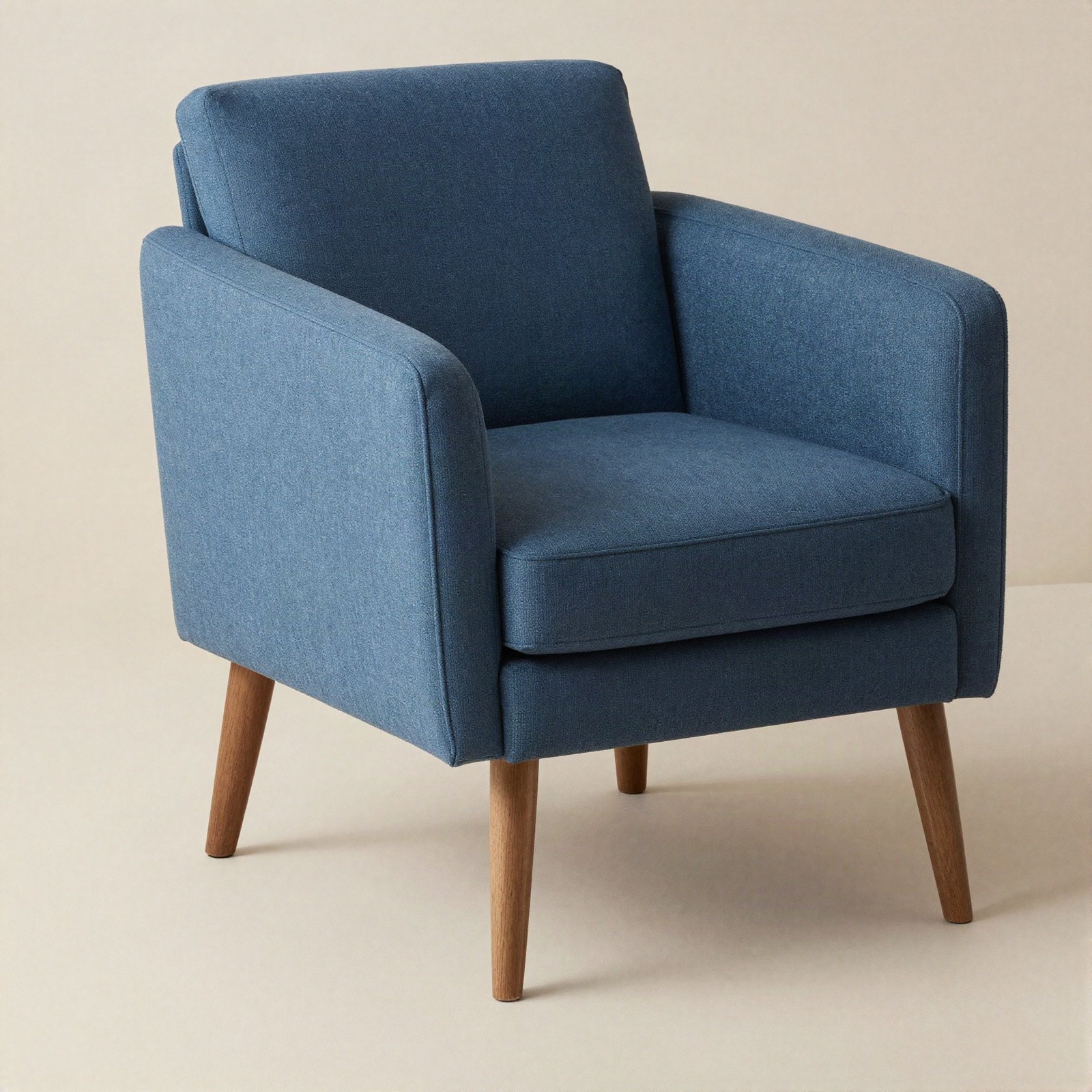 Blue fabric armchair with tapered wooden legs