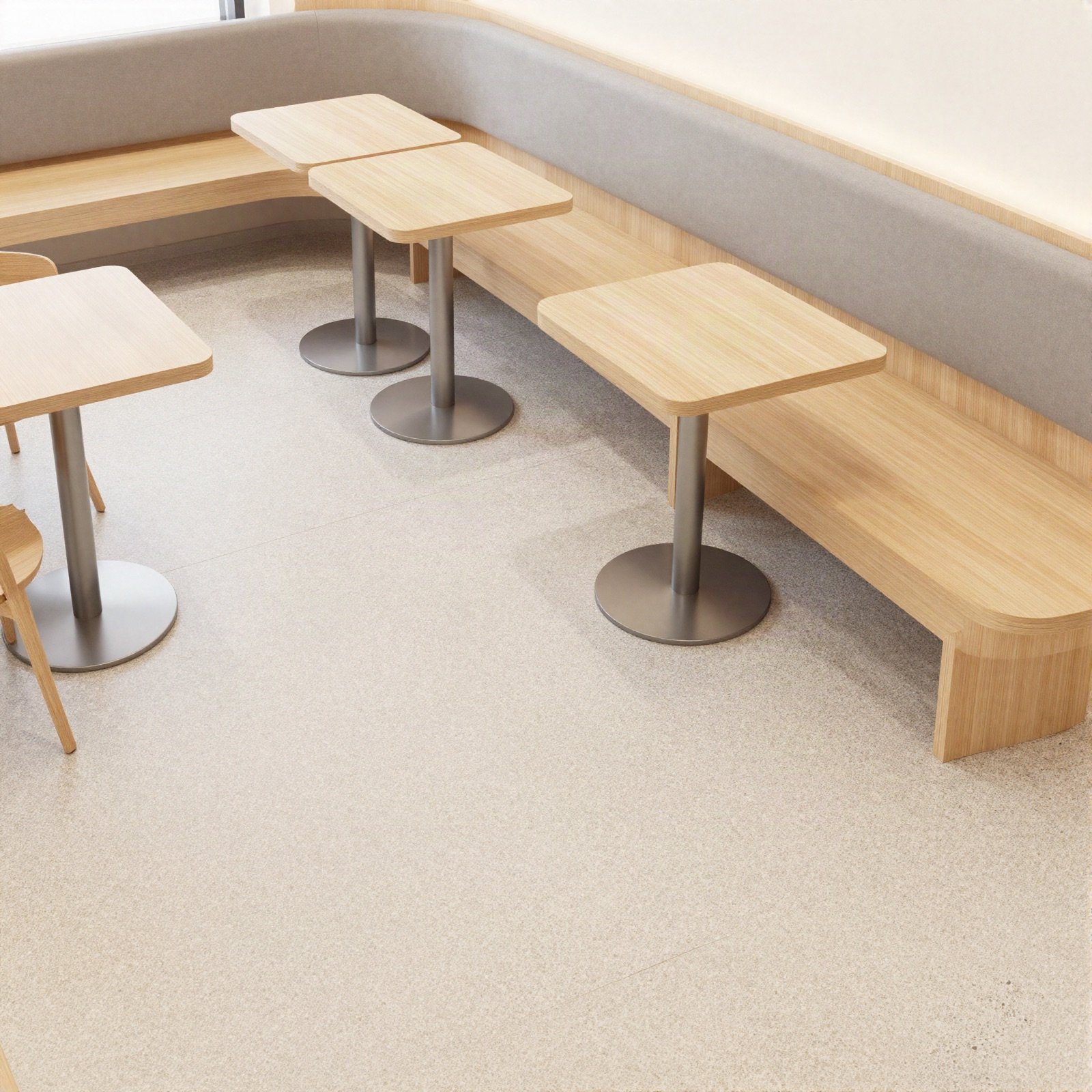 Bright cafe with curved bench seating and pale wood tables