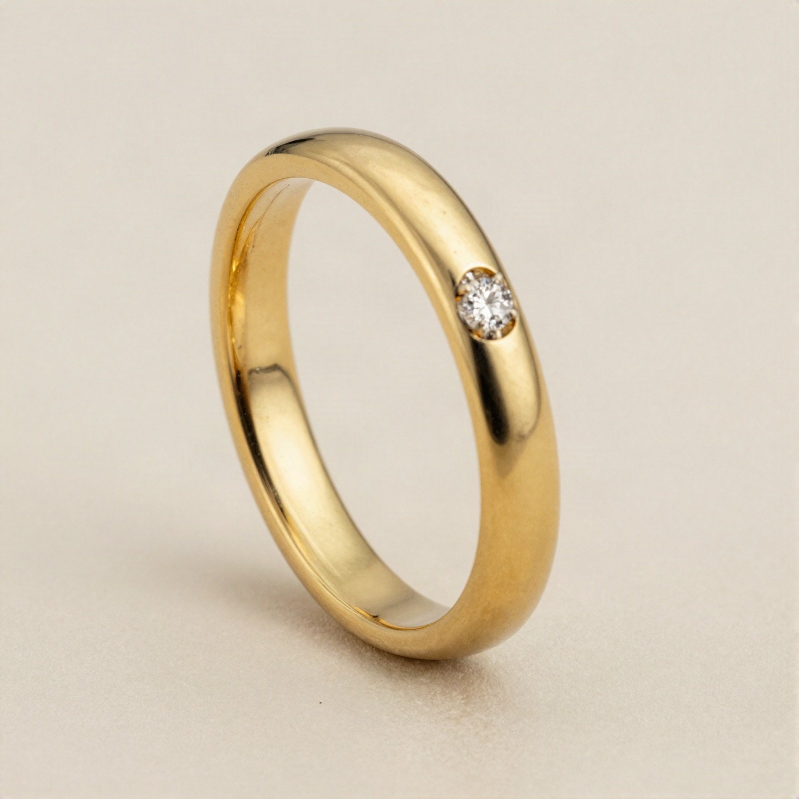 Polished gold wedding band with one flush-set diamond