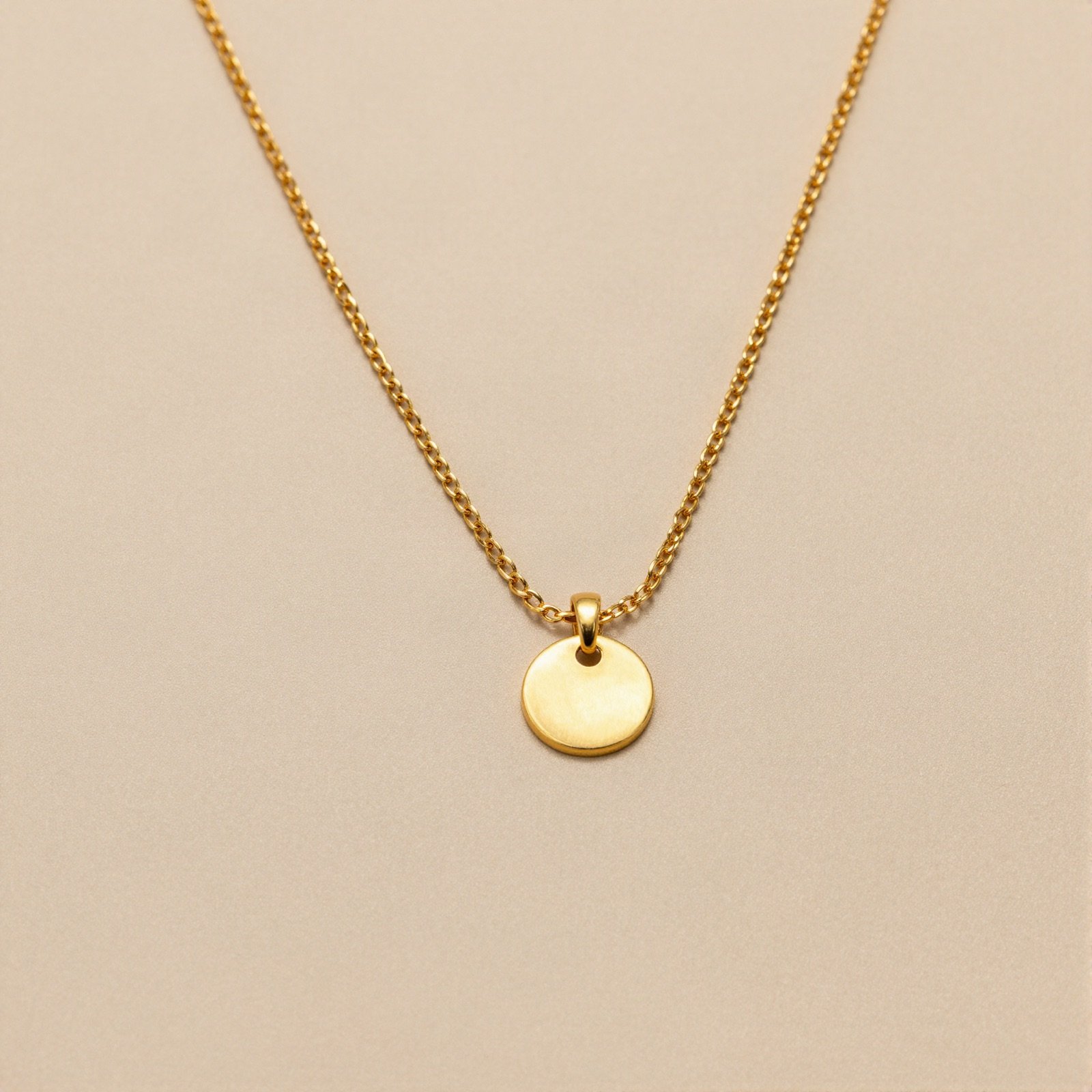 Fine gold chain with a small round disc pendant