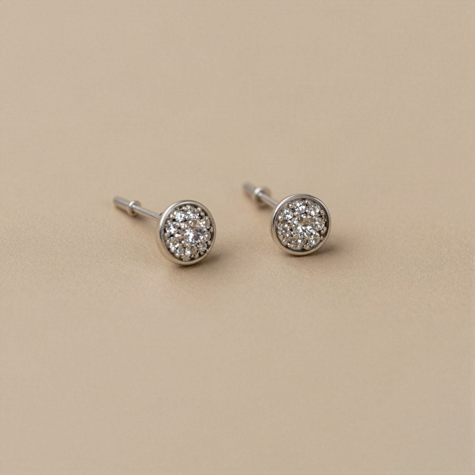 Pair of silver stud earrings set with small white stones