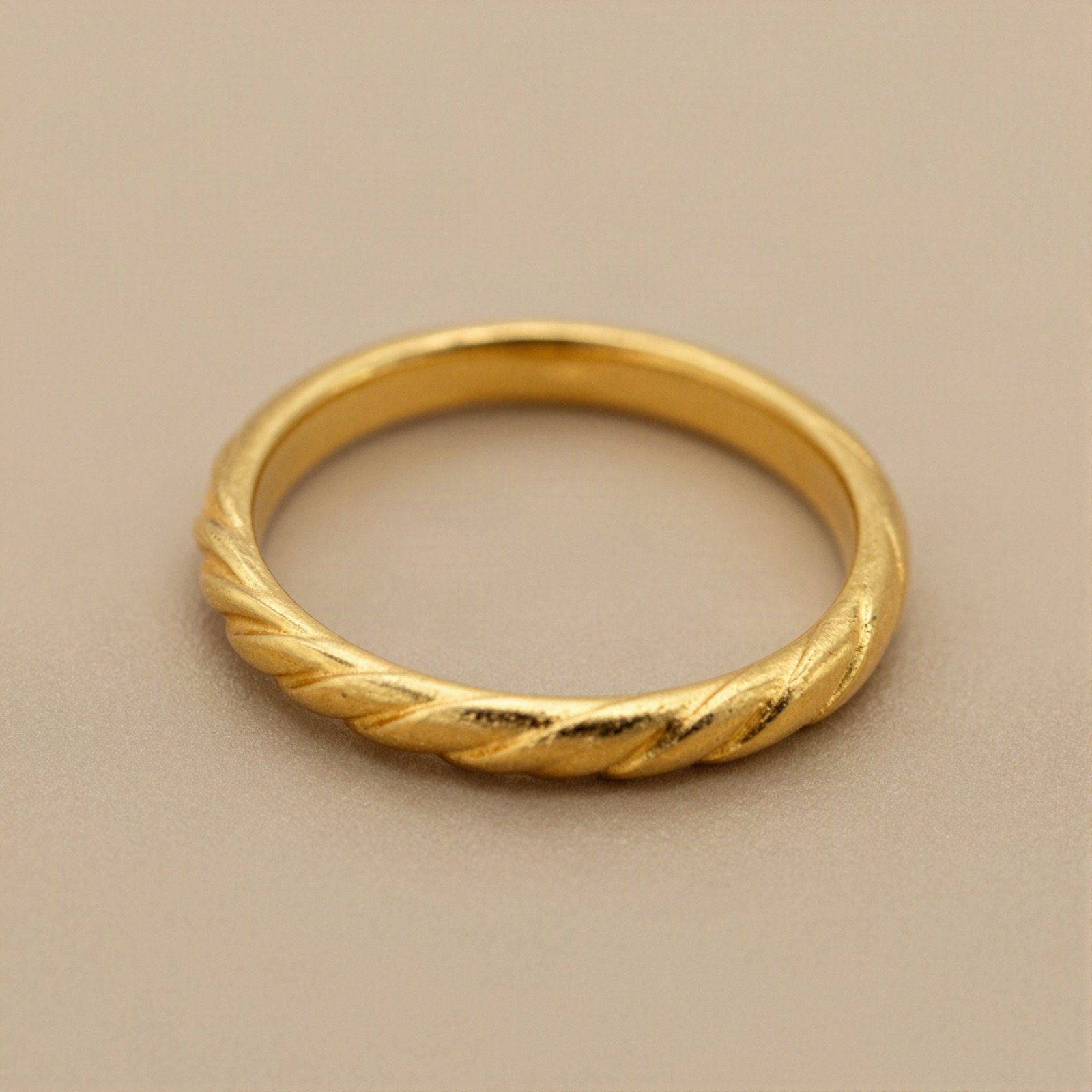 Yellow gold ring with a twisted rope pattern
