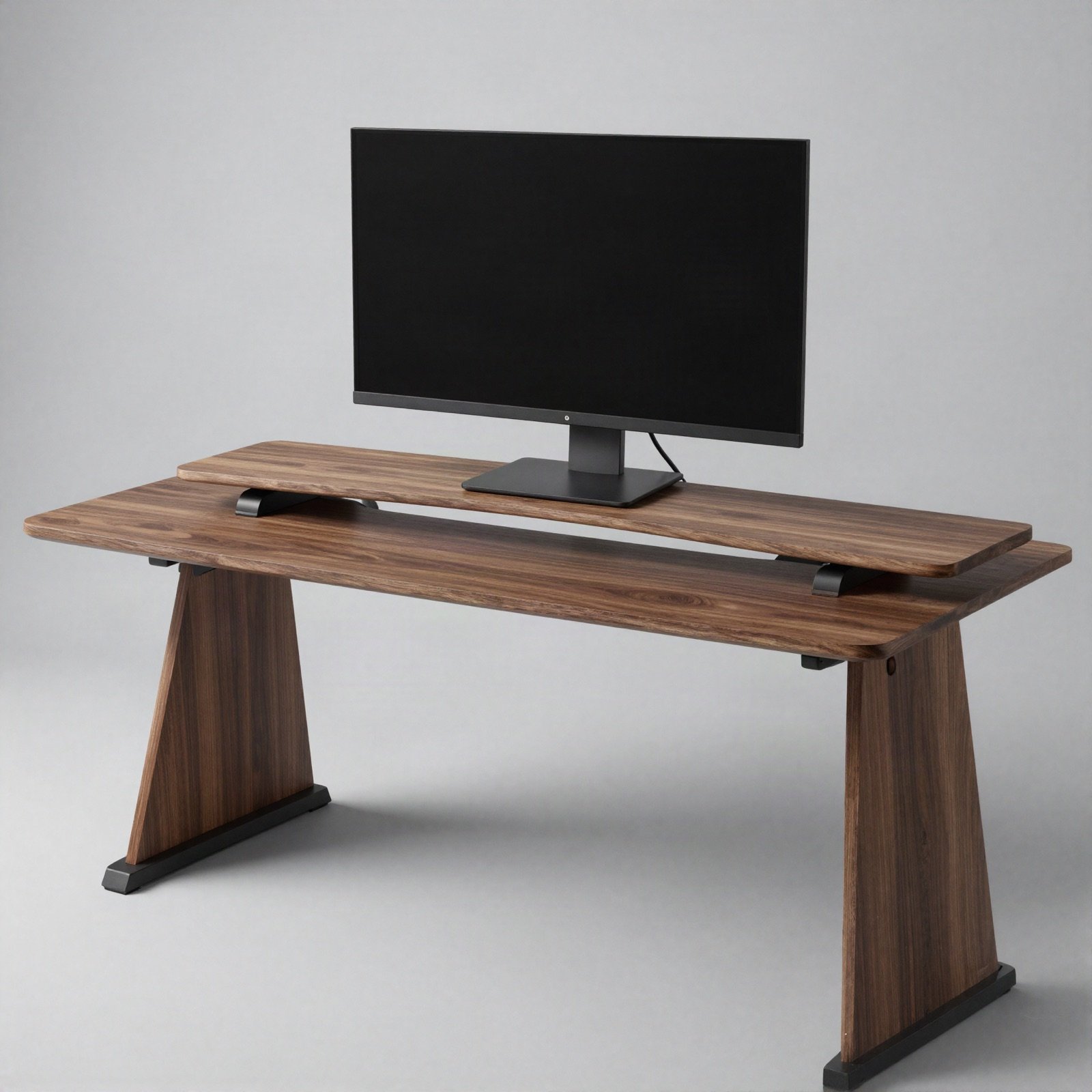 A walnut monitor riser shelf lifting a monitor above a walnut desk