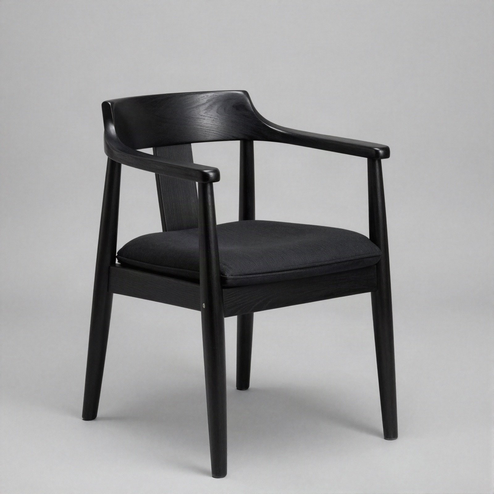 A black wooden armchair with a padded seat