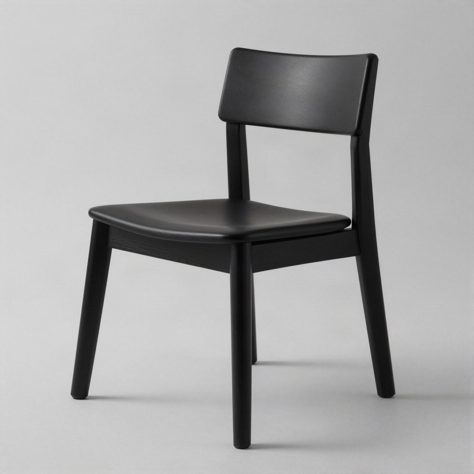 A simple black chair with a solid wood frame