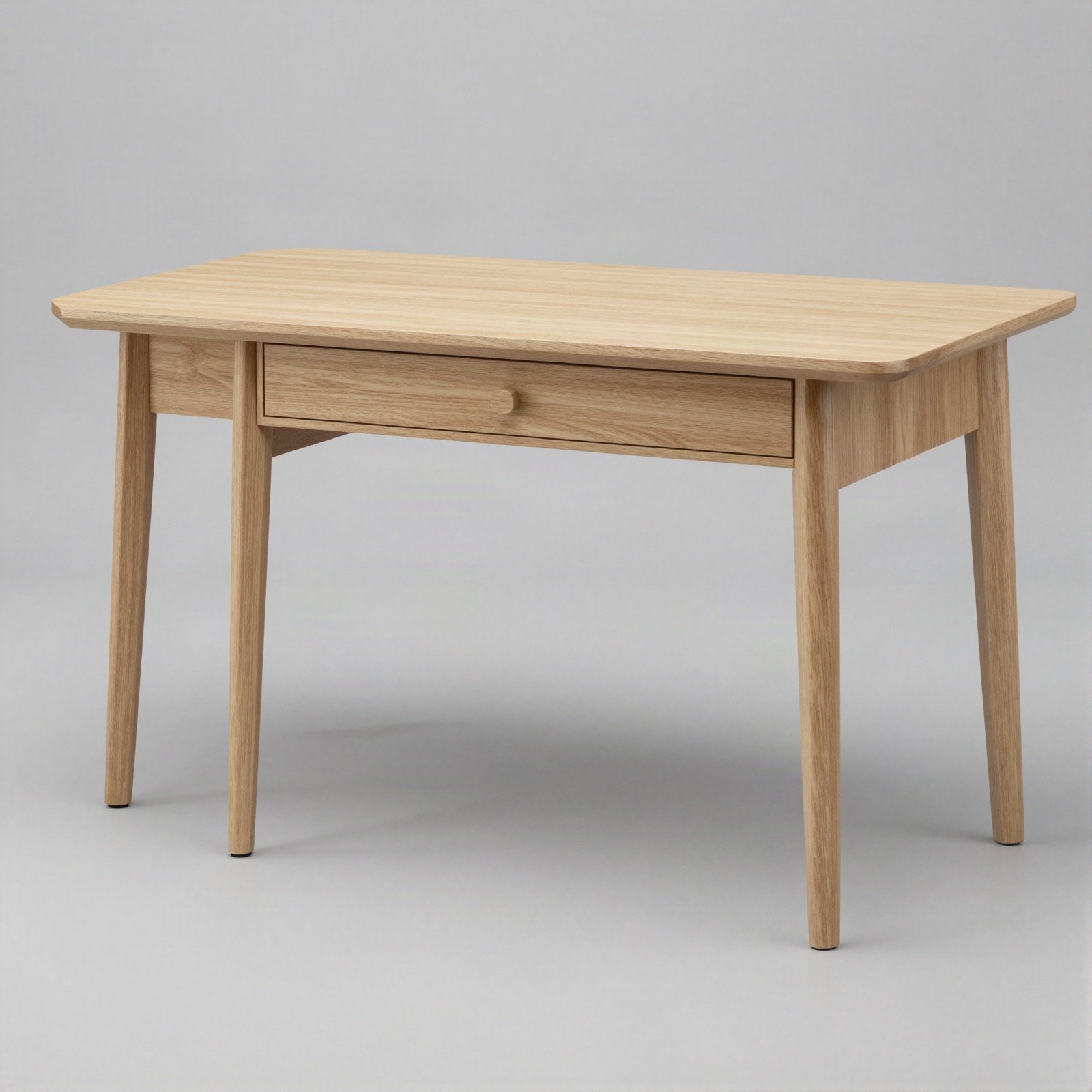 A minimalist light oak desk with a slim drawer