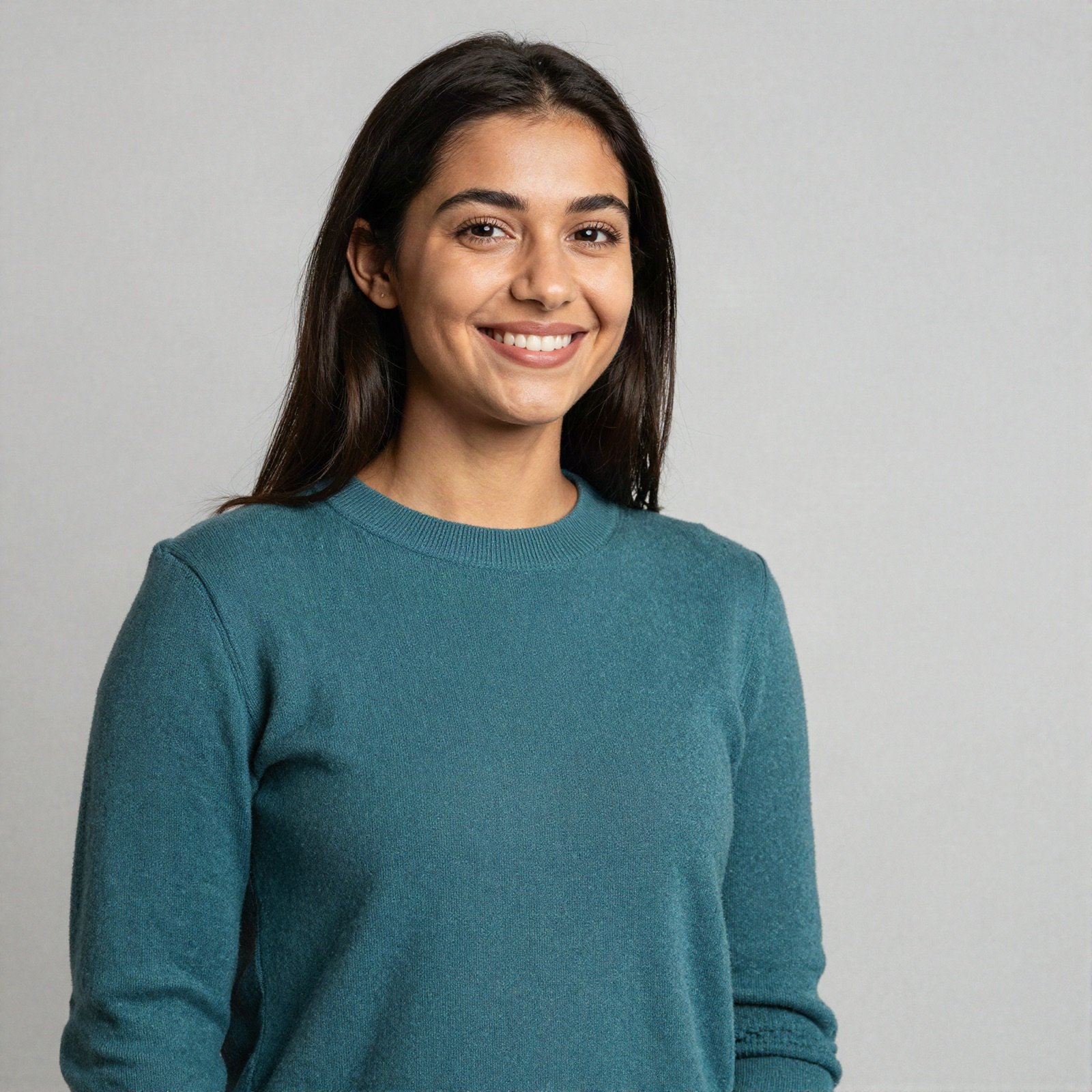 Portrait of a smiling young woman in a teal sweater