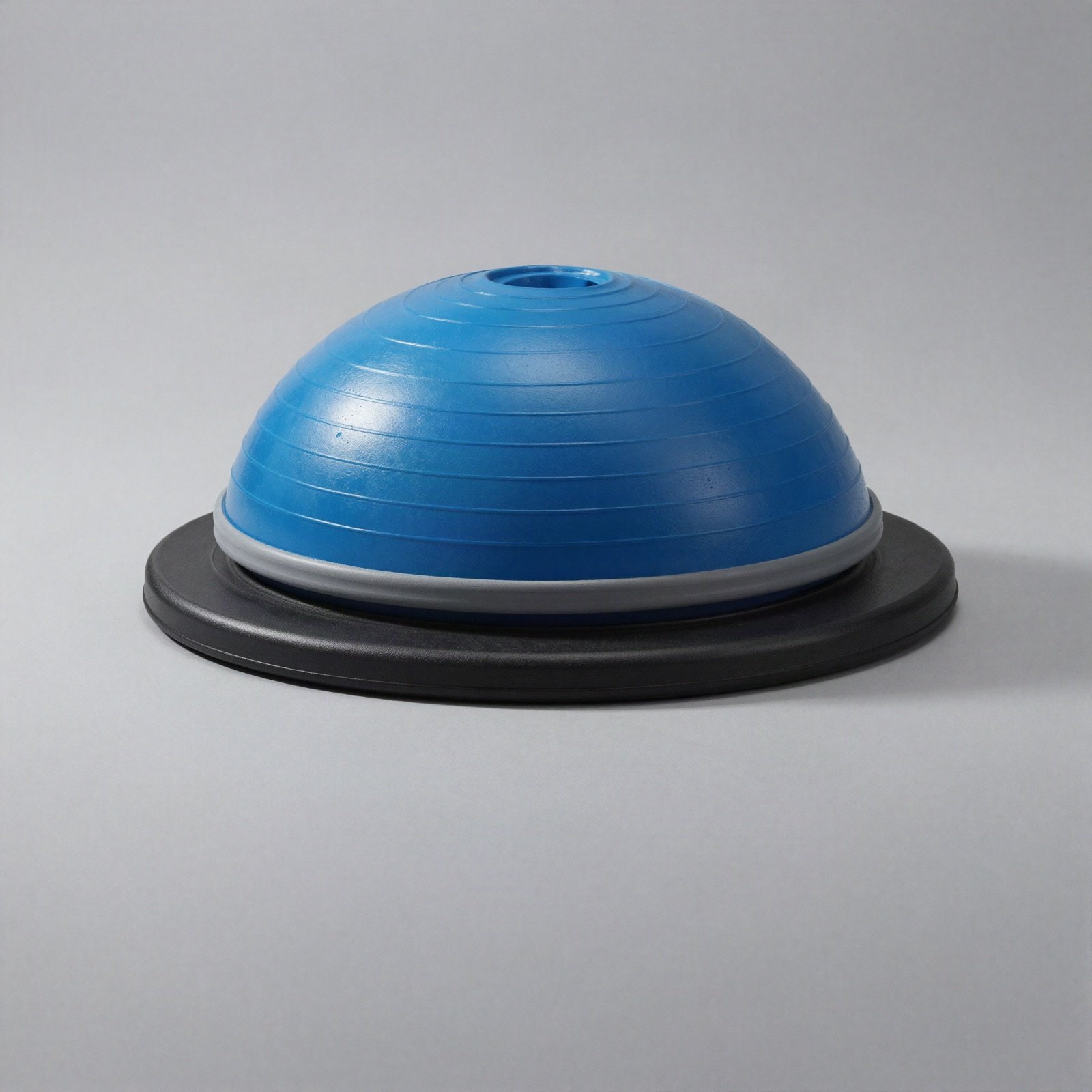 A blue half-dome balance trainer on a black base
