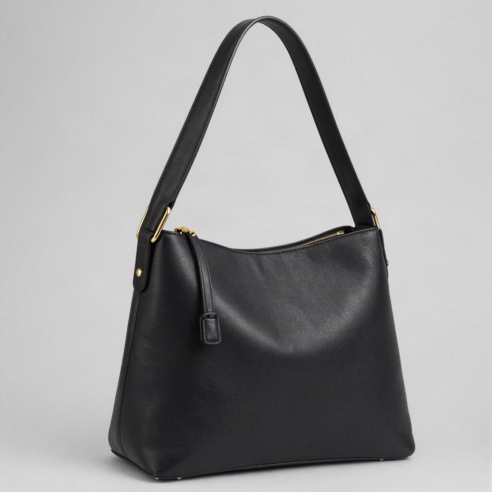 A black leather shoulder bag with gold hardware