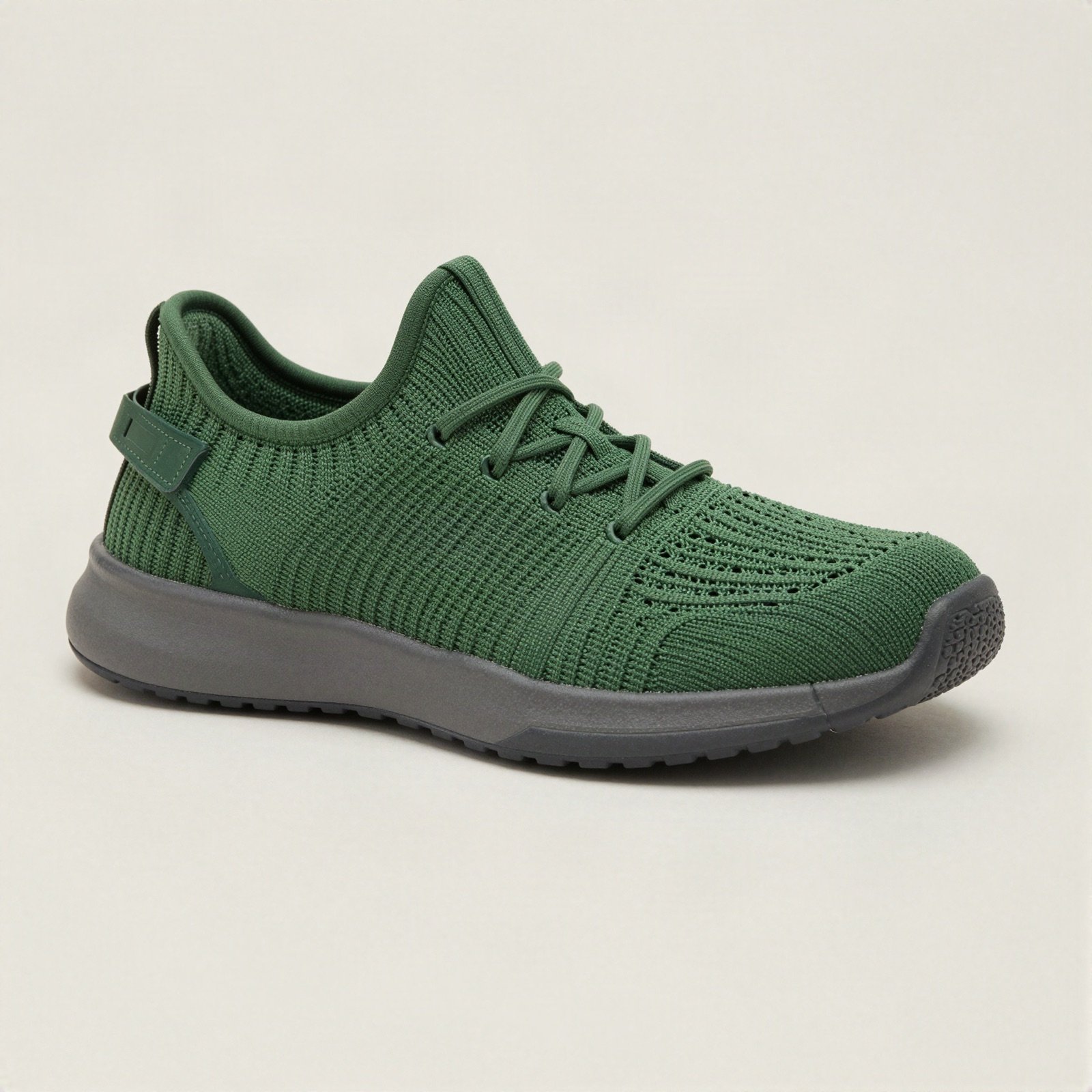 Green knit sport shoe with a grey sole